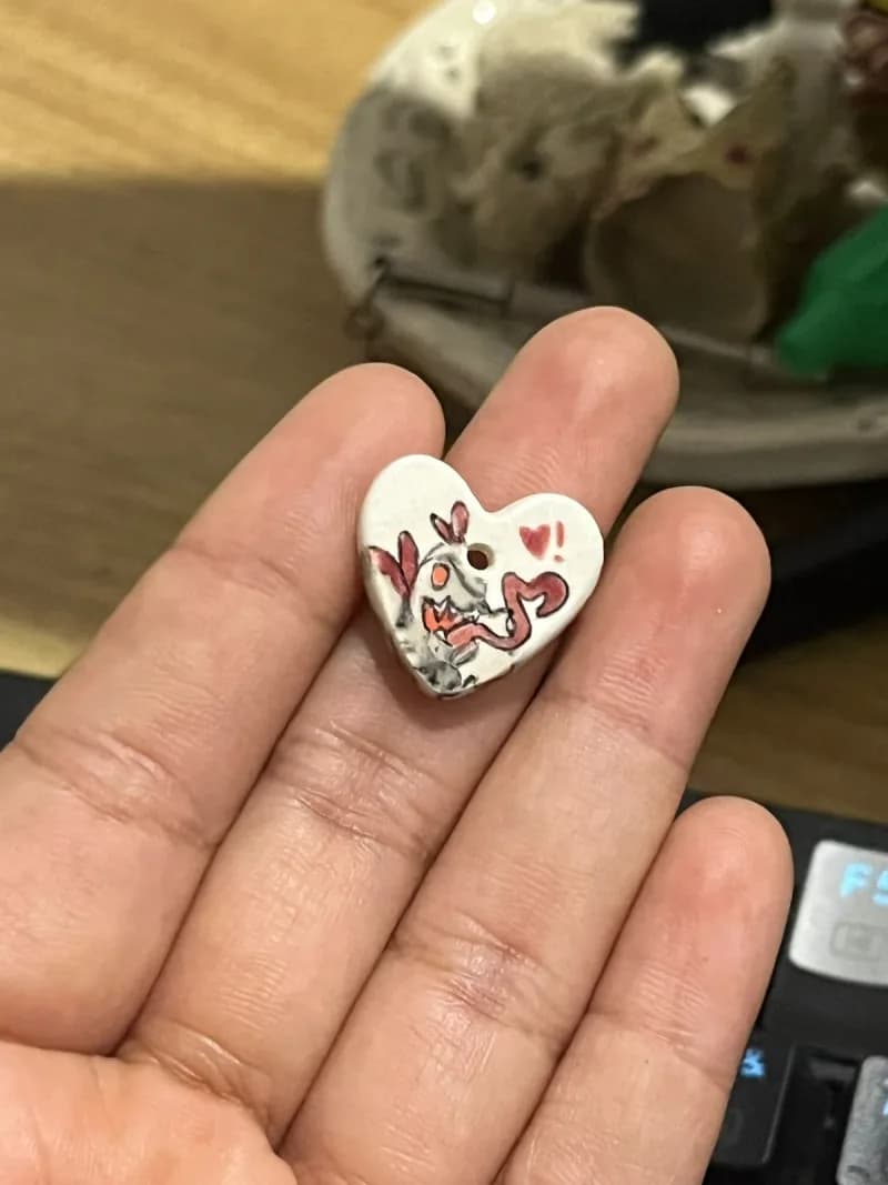 Heart-shaped button with painted bunny